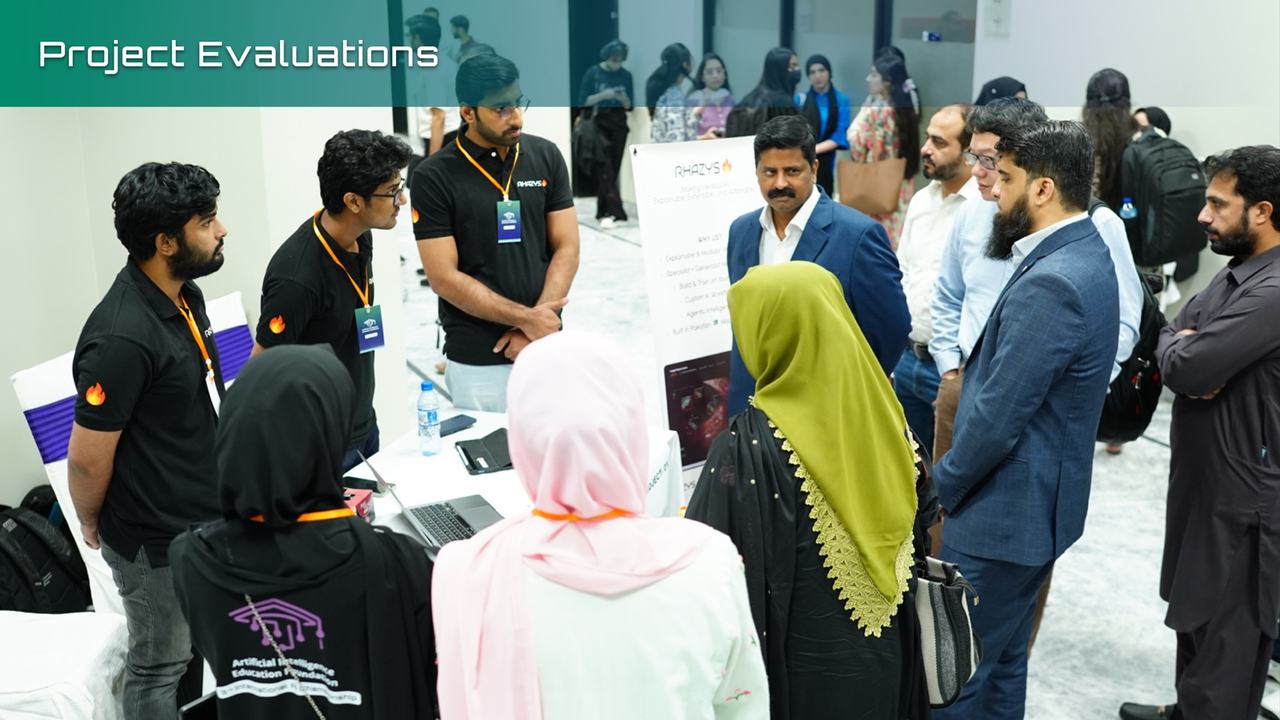 Judges evaluating a team's project at their booth